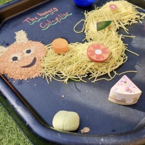 A bunch of materials laid out on a mat for messy play.
